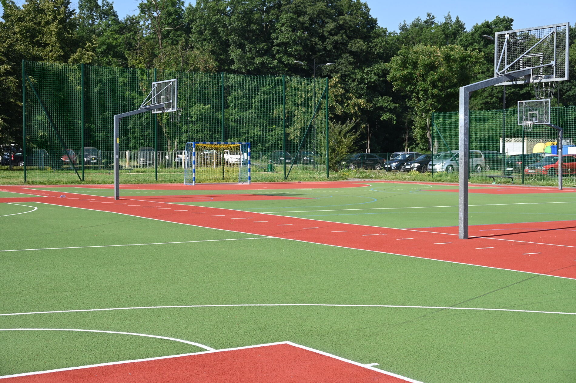 Widok na kolorowe, wyremontowane boisko.