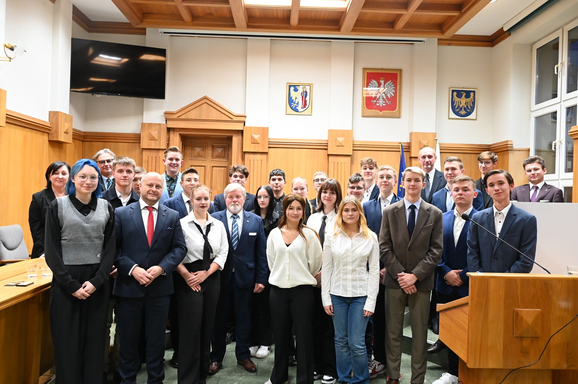 grupa osób w pomieszczeniu stoi i pozuje do zdjęcia